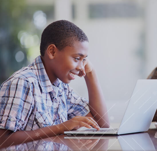 boy coding on laptop