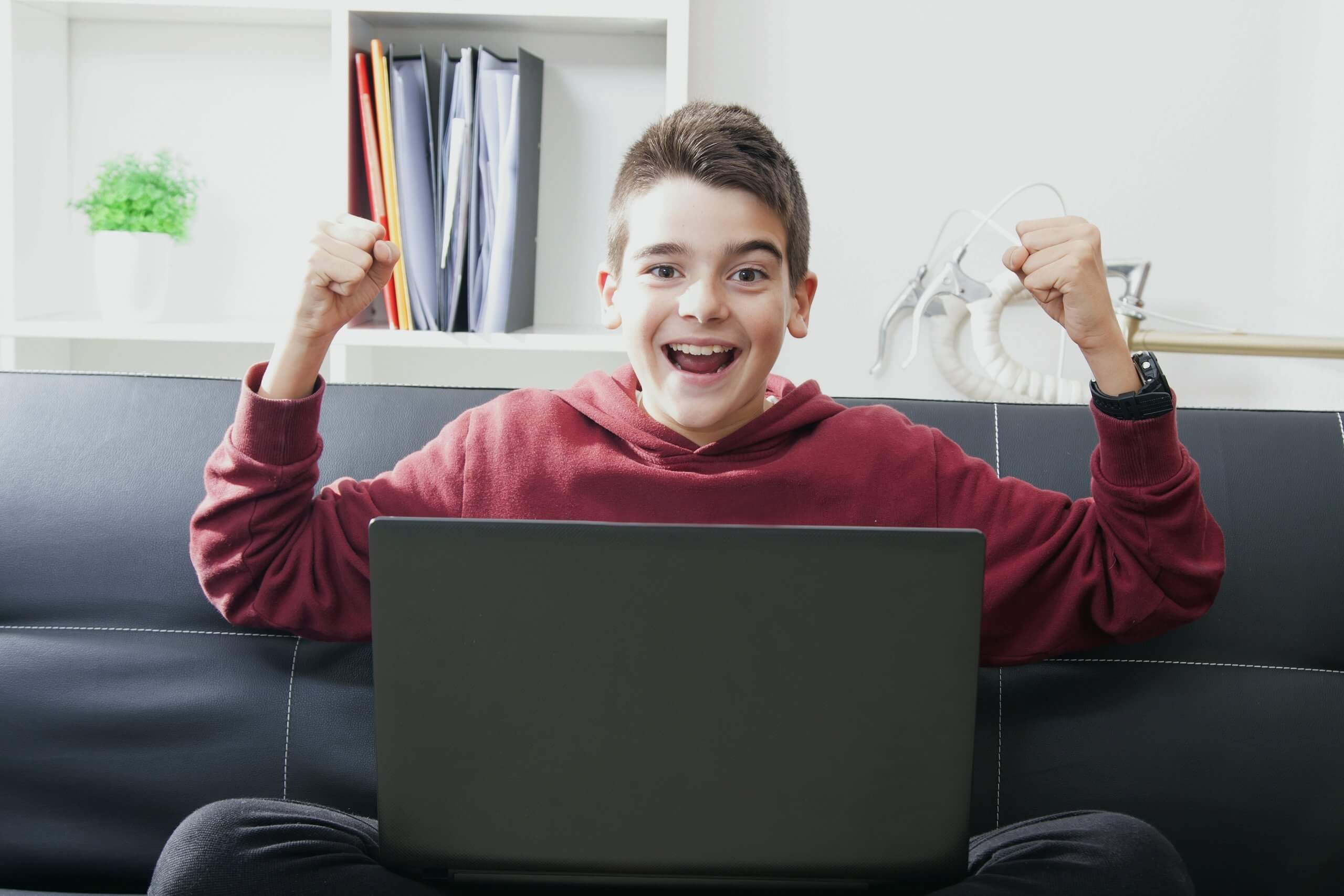 Teen boy excited on computer coding