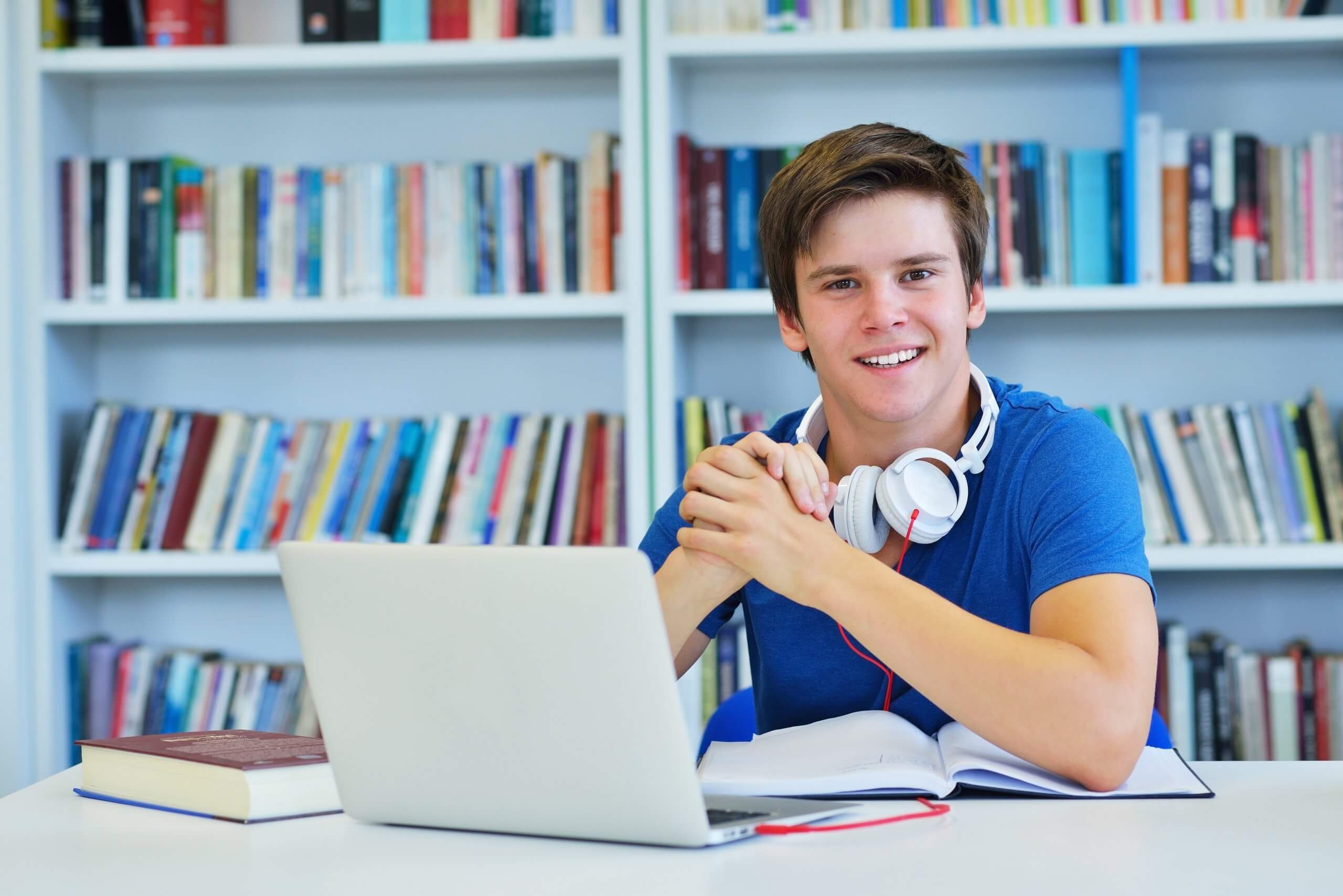 Excited elementary student in coding class sitting at computer