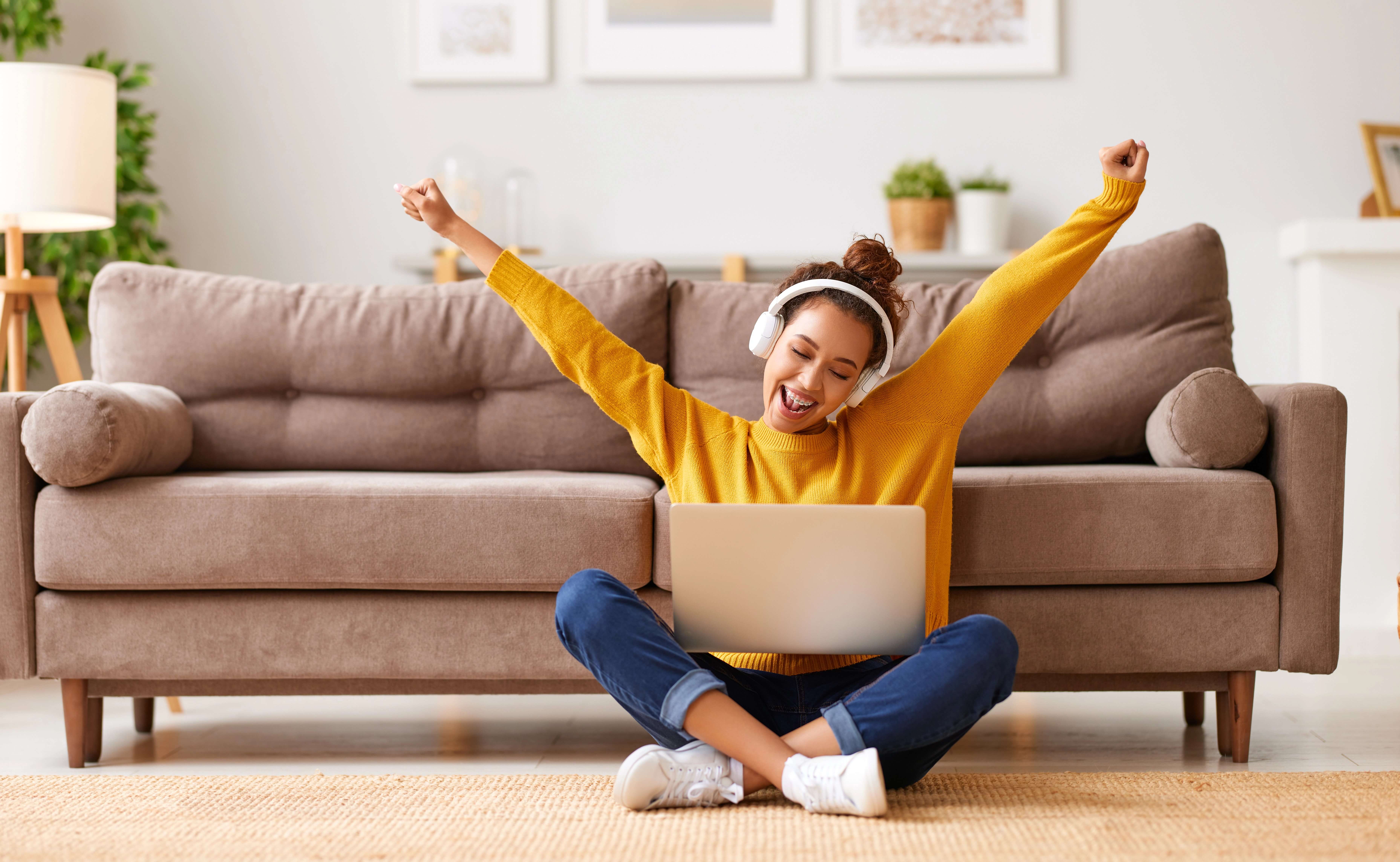 excited teen girl coding on computer